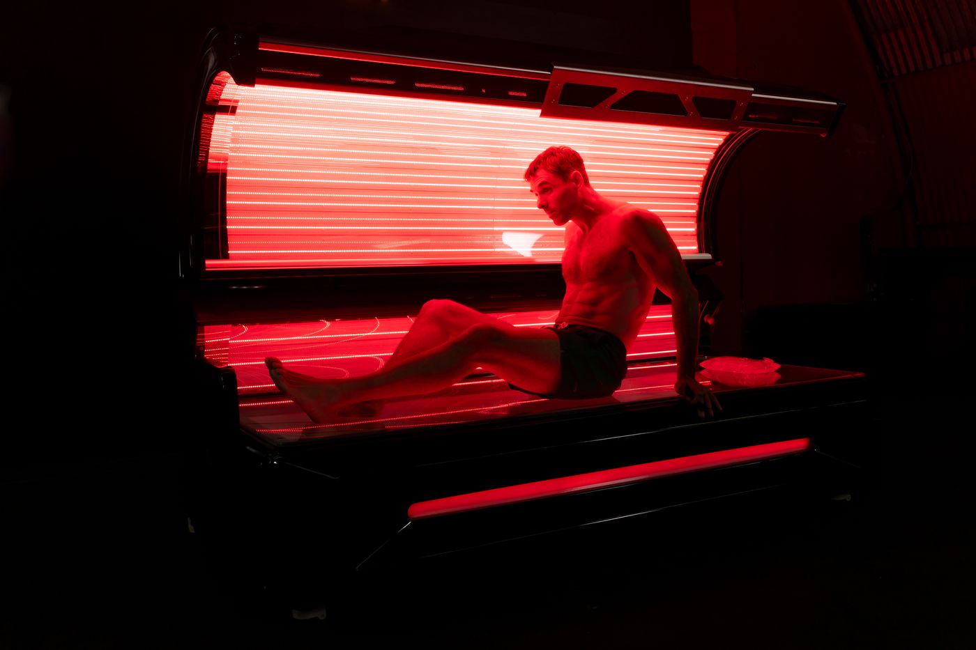 Relaxing under the LumiRed REGEN red light wellness bed